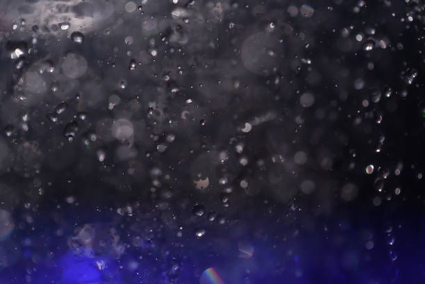 istock Multicolored spray fountain at night 857174034