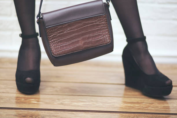 istock Woman sexy legs with handbag 857178518