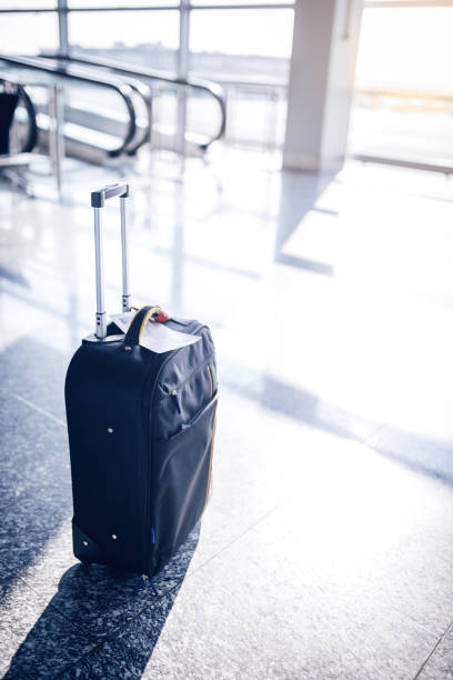istock Black suitcase at airport 857186236