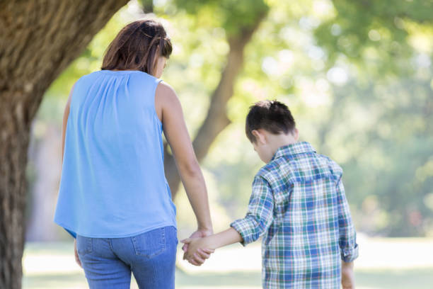istock Mom and son walking hand in hand 857187290