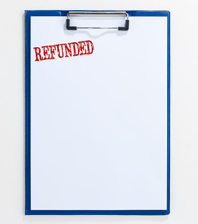 looking down on a notepad quoting “Refunded” written with rubber stamp