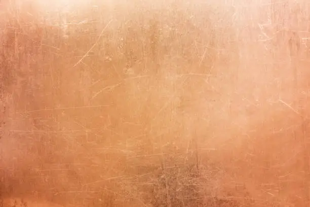 Old brass or copper background, texture of a vintage orange metal plate
