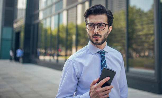 istock Businessman in city using phone 857197050