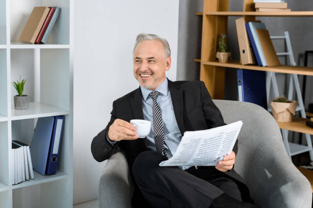 istock businessman in armchair drinking coffee 857197266