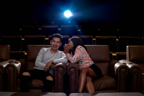 istock Whispering During a Movie Date 857198850