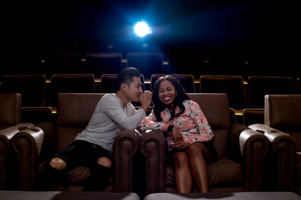 istock Whispering During a Movie Date 857198852