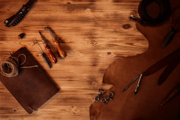 istock Leather craft. Tanner's tools on grey wooden background top view.Copyspace 857208950