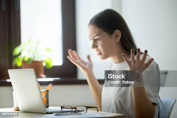 Millennial Generation Woman Looking In Laptop Computer Fling Arms Up Stock Photo - Download Image Now