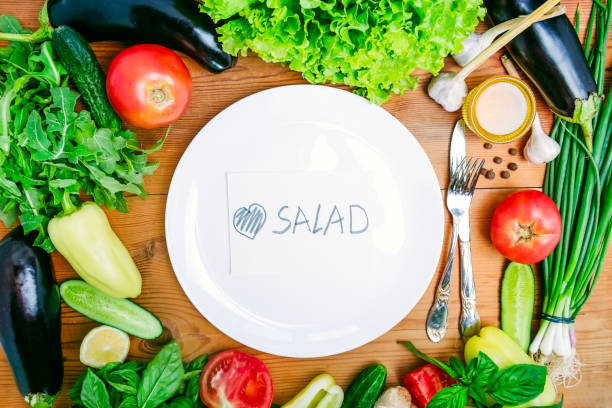istock Top view Fresh organic vegetables - ingredients for salad and white empty plate with paper note with handwritten lettering Love salad .Diet, detox, vegetarian lifestyle concept . Selective focus. 857219198