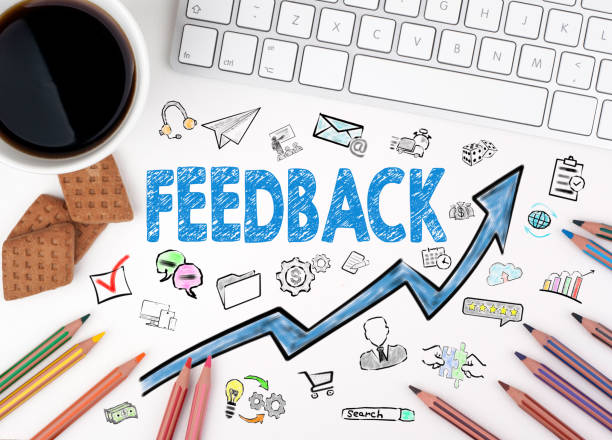 istock feedback, Business Concept. Computer keyboard and cup of coffee on a white table 857219236