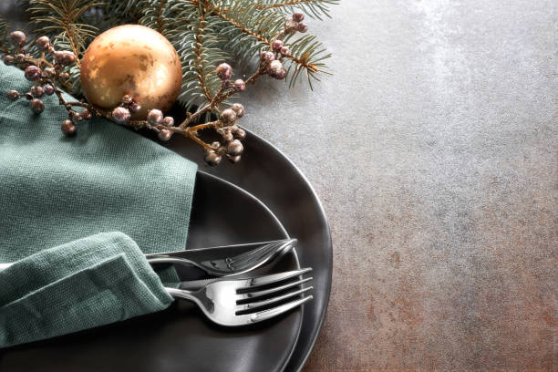 istock Christmas menu concept with decorated black plates and cutlery 857229270