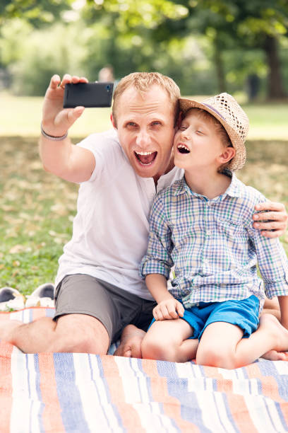 istock Father and son make a self photo in summer park 857229374