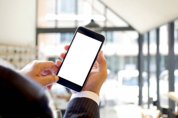 istock Businessman holding Smartphone in office. 857229944