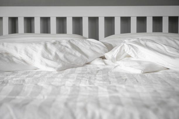 istock The white bedroom has a crumpled blanket. 857233062