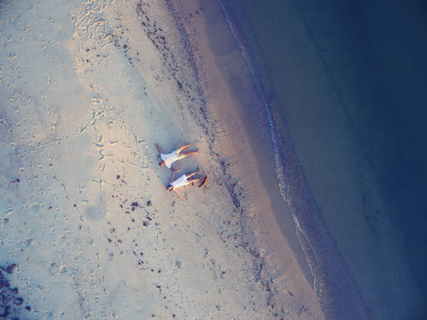 istock Romantic couple is lying on the beach 857233108