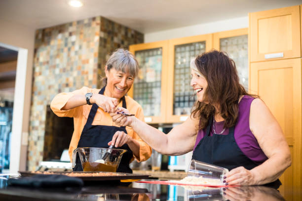 istock Senior Women Friends Cooking in Kitchen 857234070