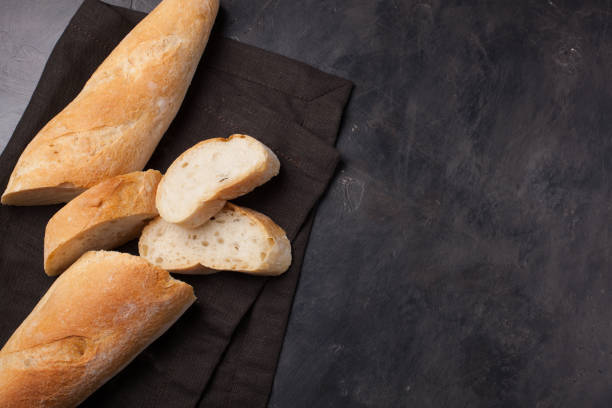istock Sliced bread over dark stone table. View from above with copy space 857234184