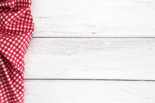 istock Crumpled red checkered tablecloth or napkin on empty white wooden table with copy space for food cooking  menu background concept , top view or overhead shot 857236716
