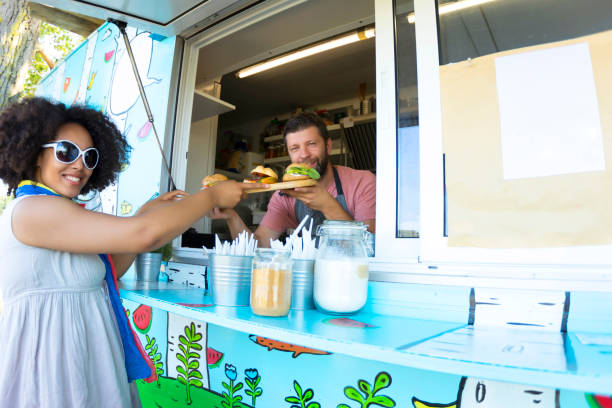 istock Male food van worker giving order to customer 857237398