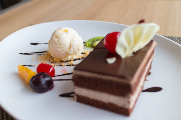 istock chocolate layer cake and vanilla ice cream with fresh fruit and cherry 857238432