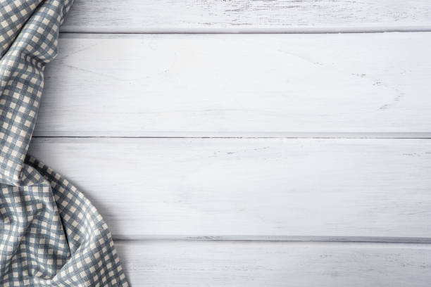 istock The Crumpled checkered tablecloth or napkin on empty white wooden table with copy space for food cooking  menu background concept , top view or overhead shot 857244270
