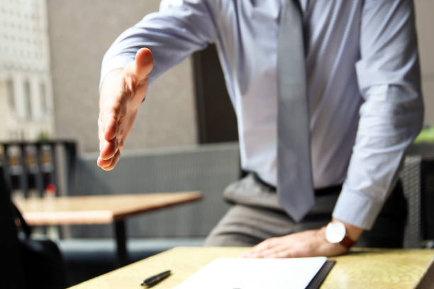 istock A business man with an open hand extended to handshake 857244770