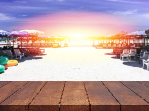 istock Empty top wooden table blurred sea of sunset background 857249840