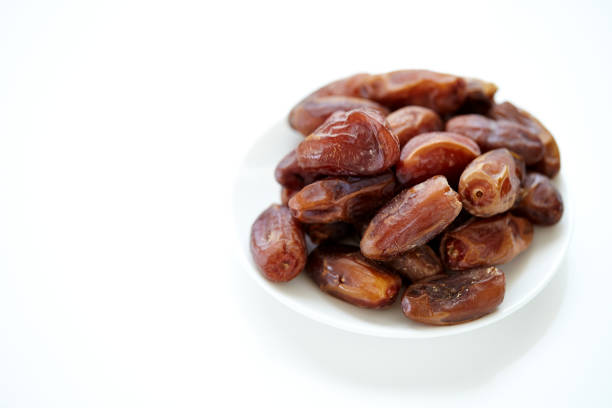 istock Bowl of dried dates isolated on white Background 857253418