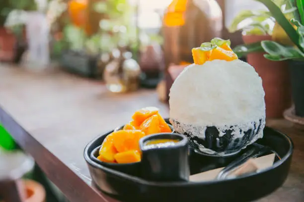 Photo of Bingsu Mango Fruity topping popular asian style summer dessert sweet ice milk shaved