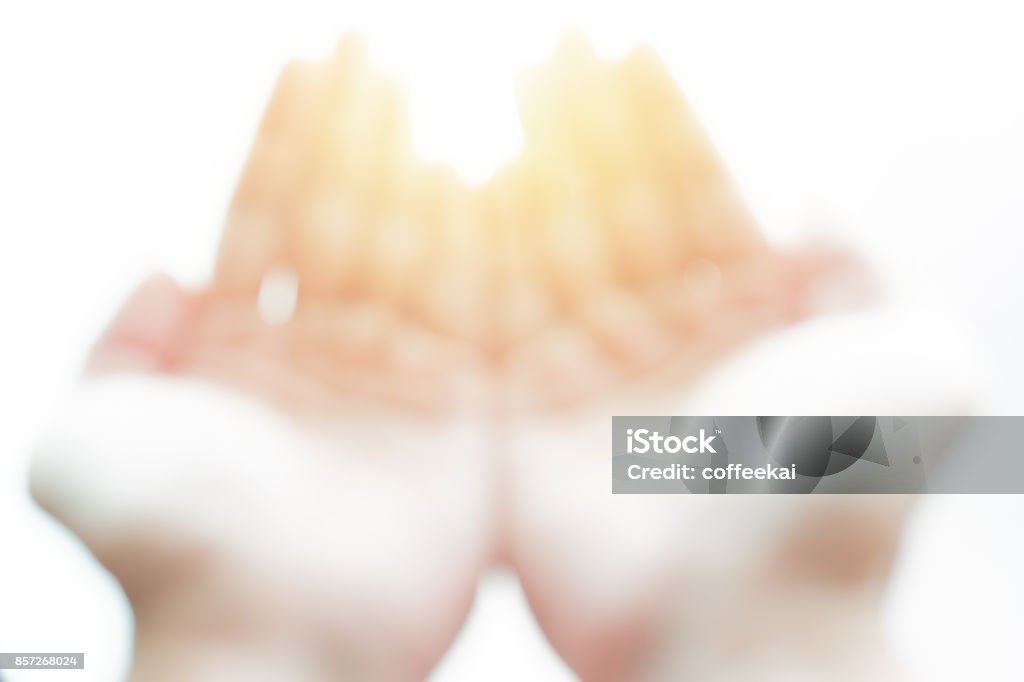 blur hand open palm on white with magic light ask god or gift from heaven concept Church Stock Photo