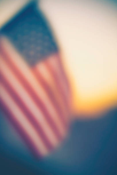 istock Autumn patriotic background with American flag in sunlight 857268334