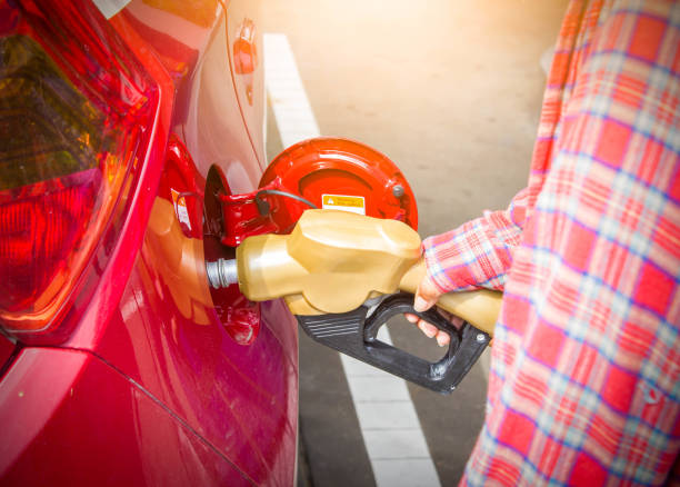 istock man pumping fuel in red car 857271442