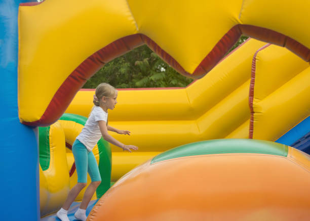istock Little girl fun fun on an inflatable trampoline. 857272086