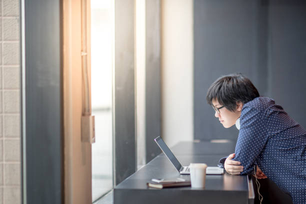istock Young Asian businessman working with his laptop computer in office 857274892