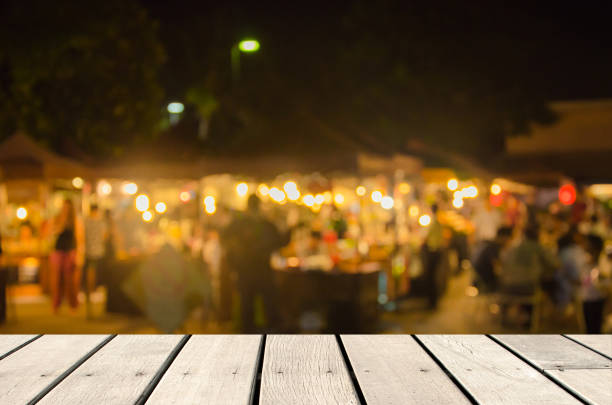 Blur food market Wood table top Abstract blurred background image for the market  food. background for product display montage night market stock pictures, royalty-free photos & images