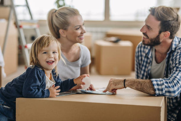 istock Happy boy having fun while moving into new apartment with his parents. 857307892