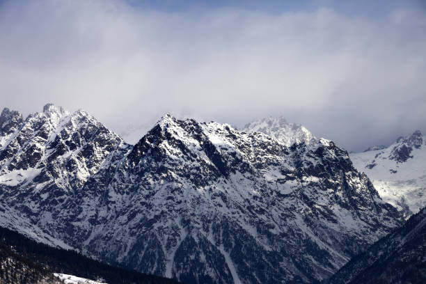 istock Snow sunlight mountain in haze at winter day 857307946