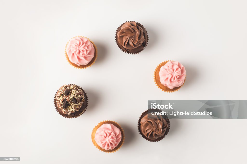 cupcakes with frosting top view of set of arranged cupcakes with frosting isolated on white Cupcake Stock Photo