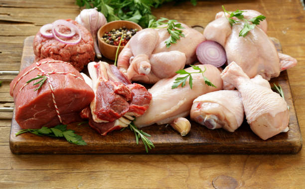 istock raw meat assortment - beef, lamb, chicken on a wooden board 857309278