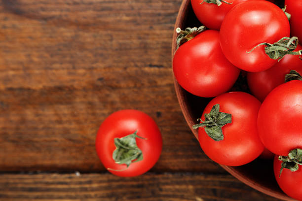 istock fresh cherry tomatoes in a clay plate 857317230