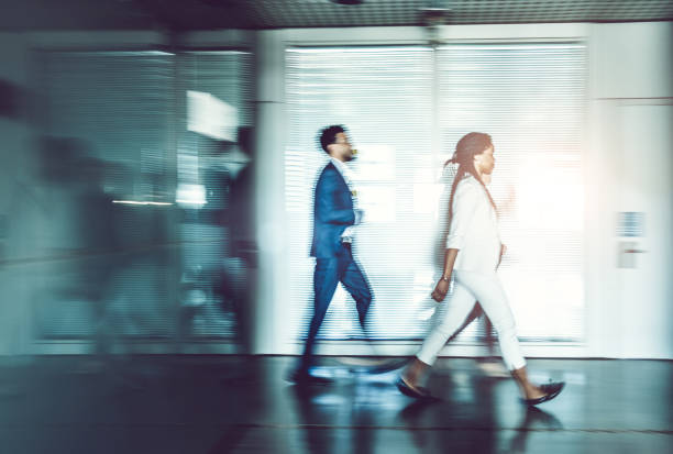 istock Business people walking along the corridor 857318696