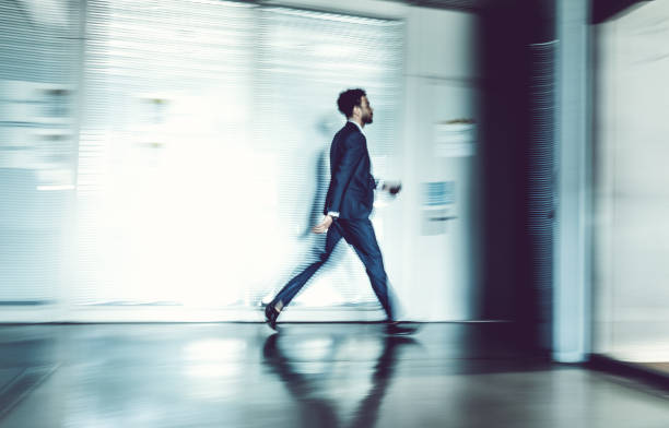 istock Business people walking along the corridor 857318782
