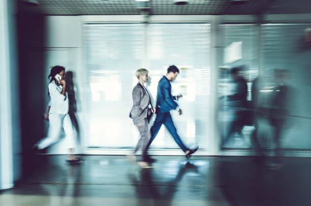 istock Business people walking along the corridor 857318794