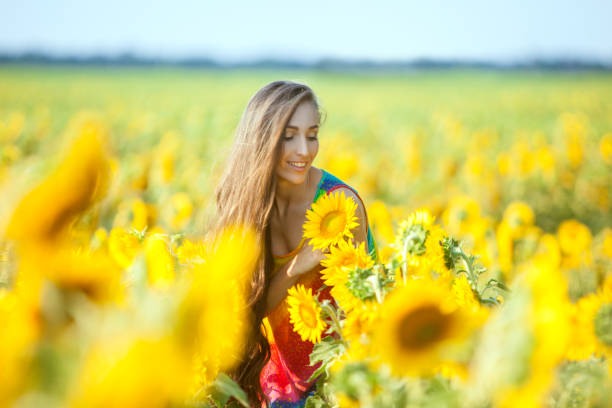 istock Woman on the field with flowers. 857323692