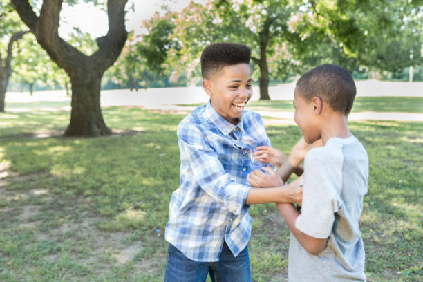 istock Brothers play in the park together 857324648