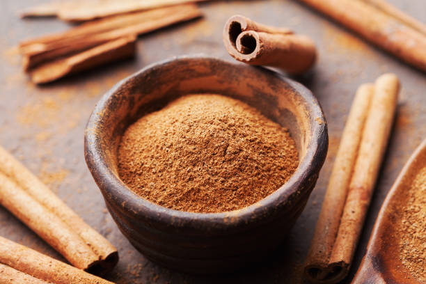 istock Whole cinnamon sticks and powder on brown rustic background. Aromatic spices. 857324728