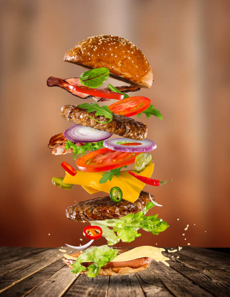 istock Big tasty burger with flying ingredients 857325884