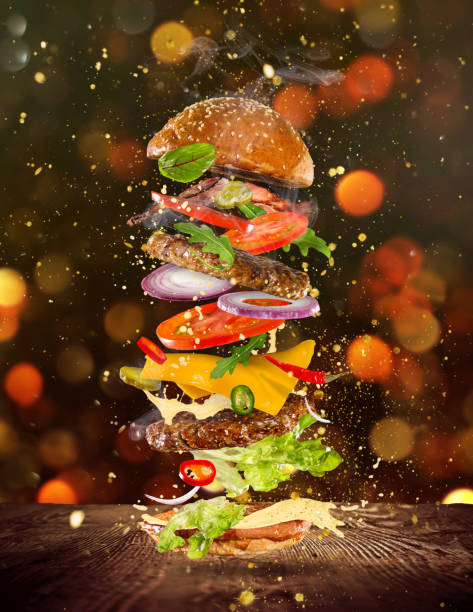istock Big tasty burger with flying ingredients 857326190