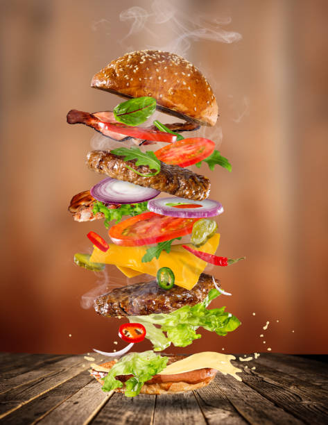 istock Big tasty burger with flying ingredients 857333442