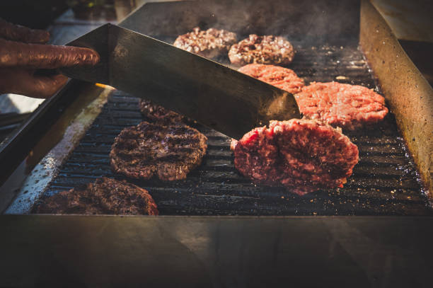 istock Flaming grill and beef burgers 857337866